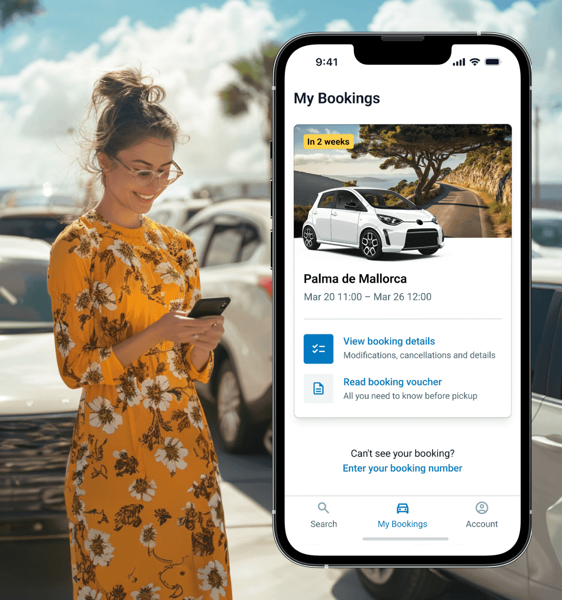 A woman looking at her phone in a parking lot