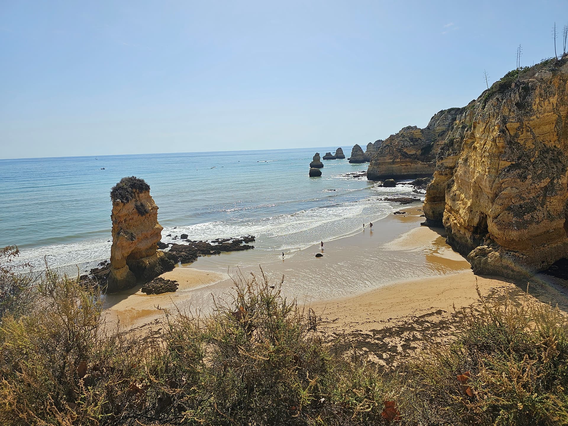 Rocky cliffs and sandy beach on a sunny day in Algarve, Portugal